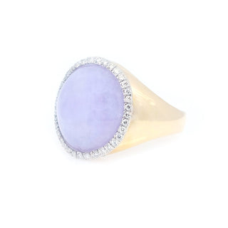 Ring with a purple gemstone and gold band on a white background